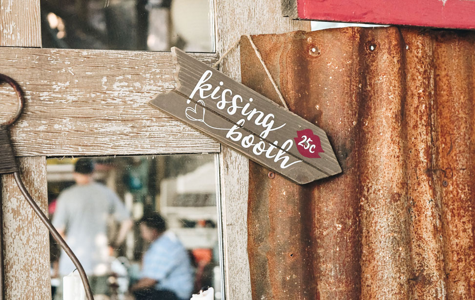 Photo of a sign reading kissing booth