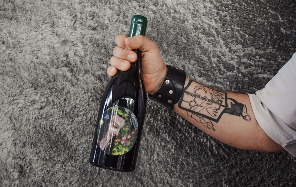 Photo of winemaker holding bottle